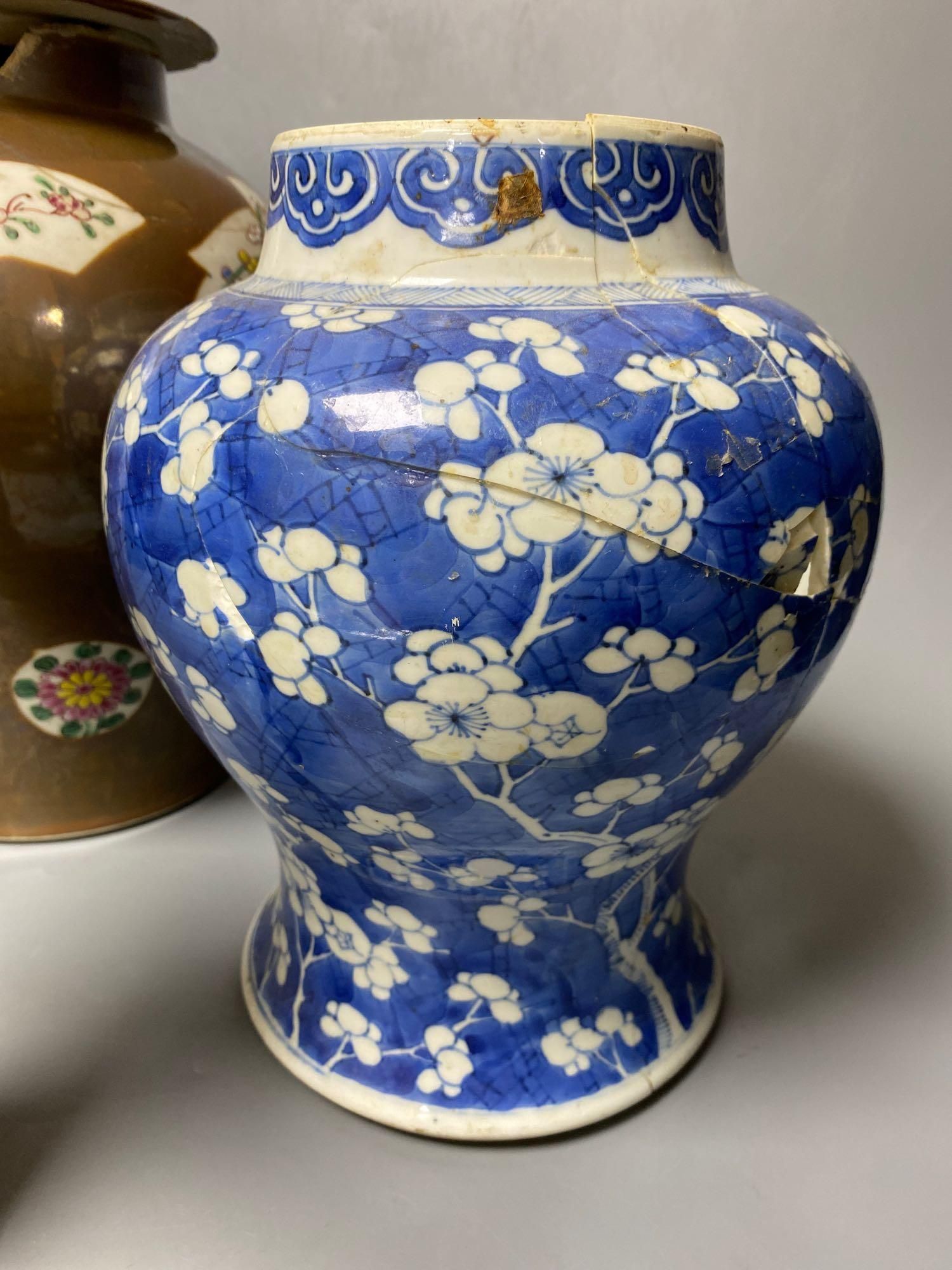 Two Chinese Kangxi period blue and white vases and a Qianlong Batavia vase and cover, largest 36cm high including the cover